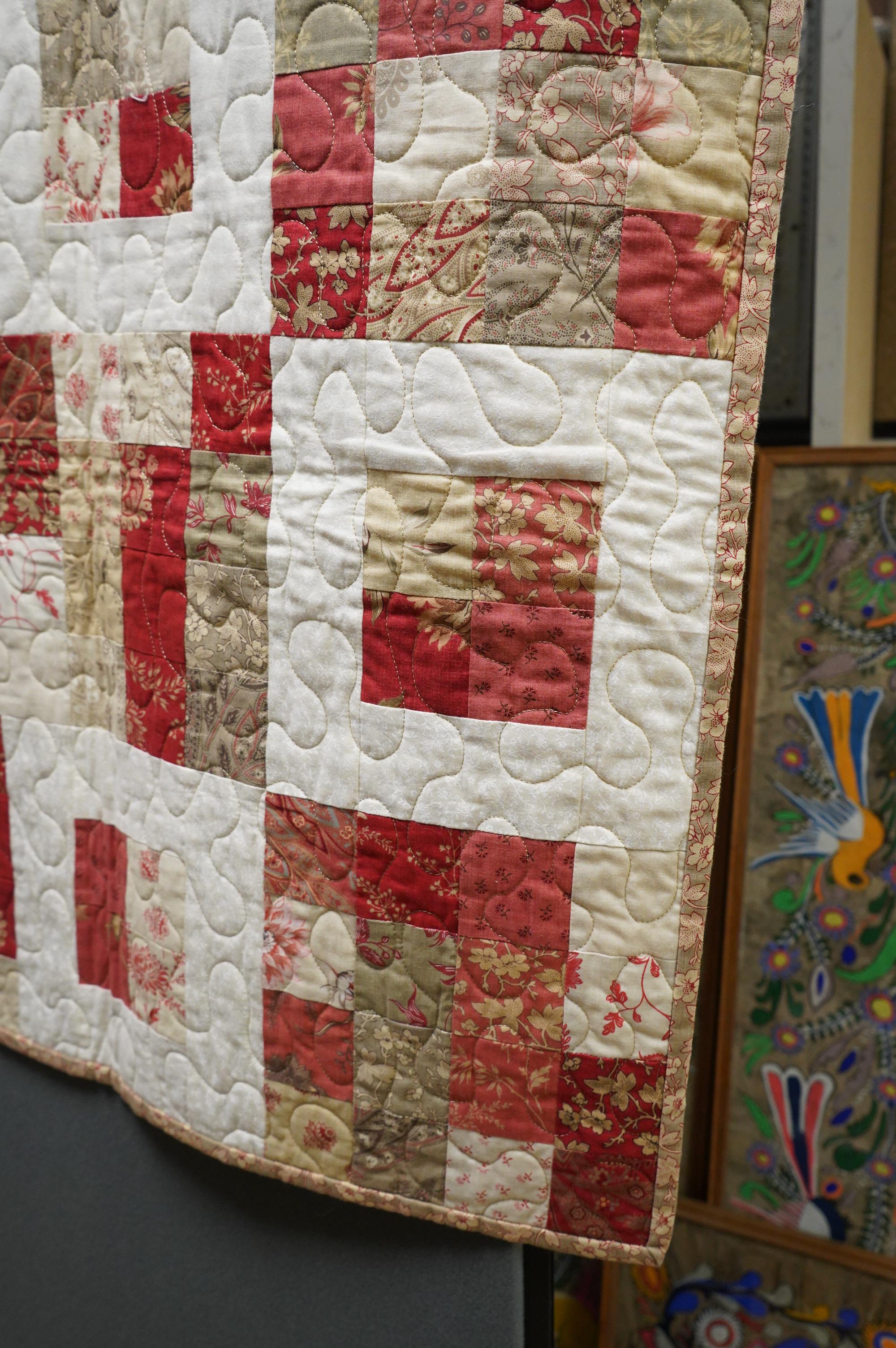 A contemporary patchwork quilt, with label: Quilts from the shed, handmade with love by Suzanne. 138cm x 136cm